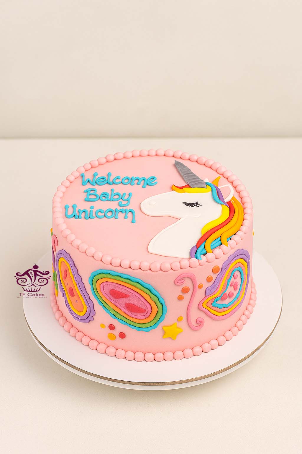 Freshly baked handcrafted Welcome Baby Unicorn Cake – Cake design by TF Cakes